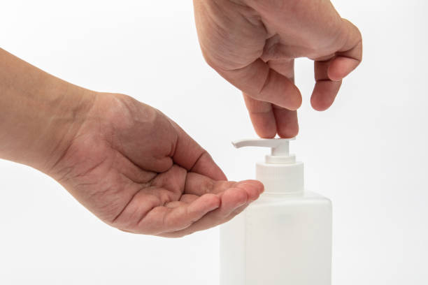 istock close up lady hand using alcohol antiseptic gel to avoid contaminating with Corona virus 1220602798