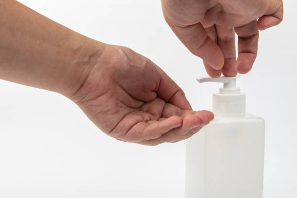 istock close up lady hand using alcohol antiseptic gel to avoid contaminating with Corona virus 1220602953