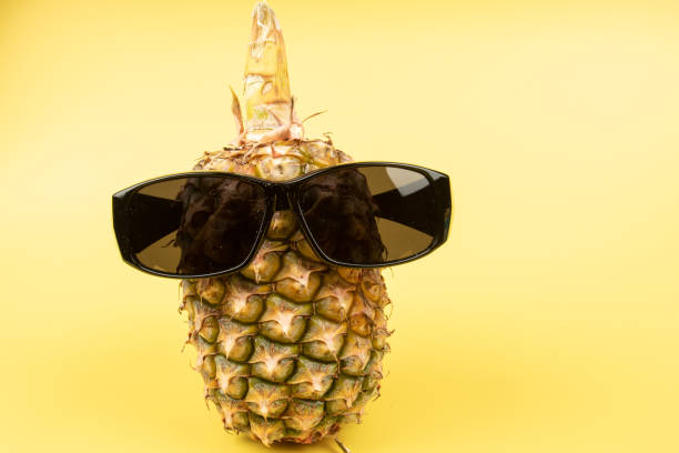 istock Pineapple wearing sunglasses on a yellow background 1220603403