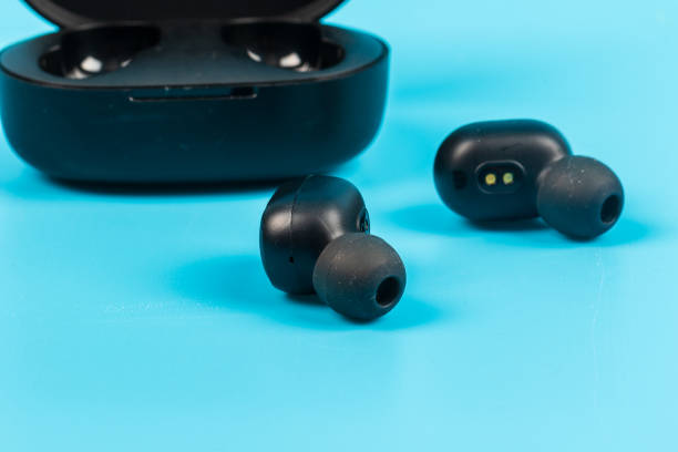 istock Wireless bluetooth headphones isolated on blue background 1220603484