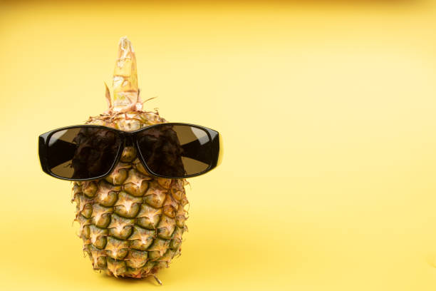 istock Pineapple wearing sunglasses on a yellow background 1220603488