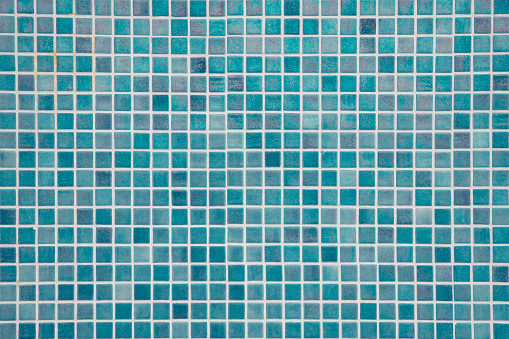 Aqua blue swimming pool mosaic tiles background, textured pool walls with copy space, a summer vacation inspiration, traveling to a tropical destination or relaxing holidays atmosphere concepts.