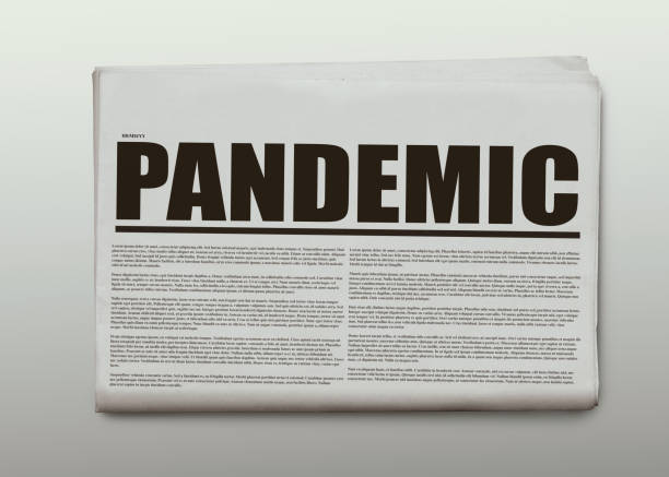 istock Pandemic written headlined newspaper isolated on a white background 1220603582