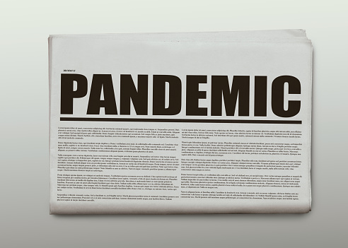 Pandemic written headlined newspaper isolated on a white background.