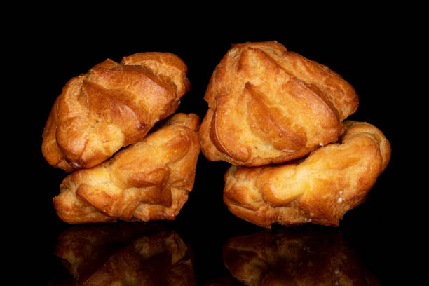 istock Sweet profiterole on black glass 1220604233