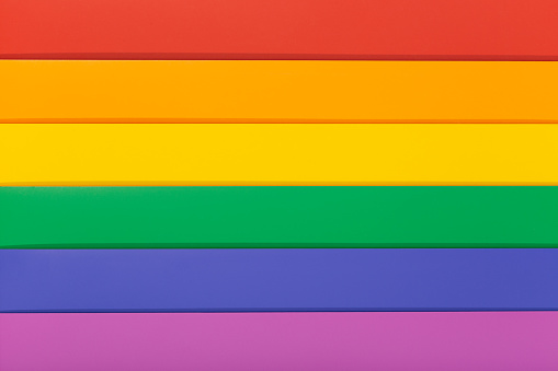 Rainbow flag background, commonly known as the gay pride flag or LGBTQ pride flag. photo of a Group of Colorful cardboard