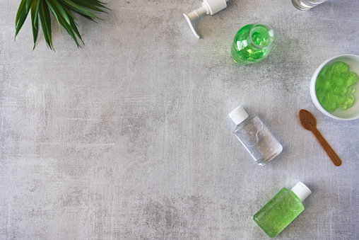 Flat lay of homemade hand sanitizer in bottles and ingredients