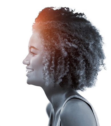 Side profile of african woman with afro isolated against a white background in a studio. Beautiful female with curly hair showing perfect skin for cosmetics and natural beauty for makeup products