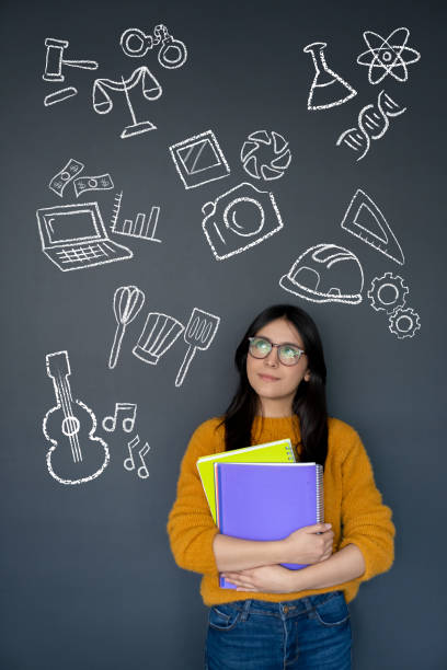 istock Happy student thinking about what to study as her major 1220610050