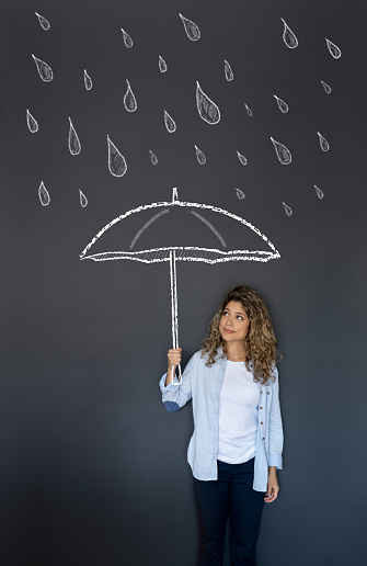 Illustration of a beautiful woman holding an umbrella under the rain