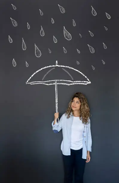 Photo of Woman holding an umbrella under the rain