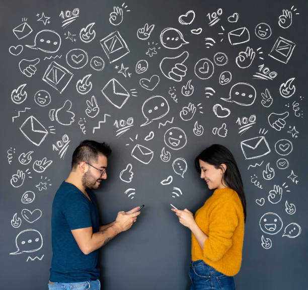 istock Happy young couple texting on their cell phones 1220610054
