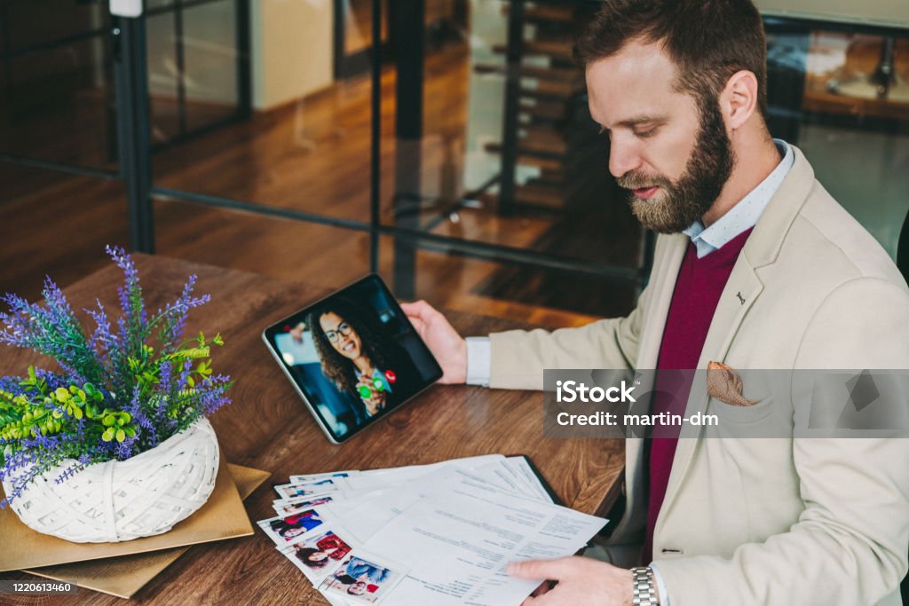 Human Resources manager recruiting on video call, COVID-19 pandemic HR manager conducting job interview with candidate on video call, COVID-19 pandemic concept Recruitment Stock Photo