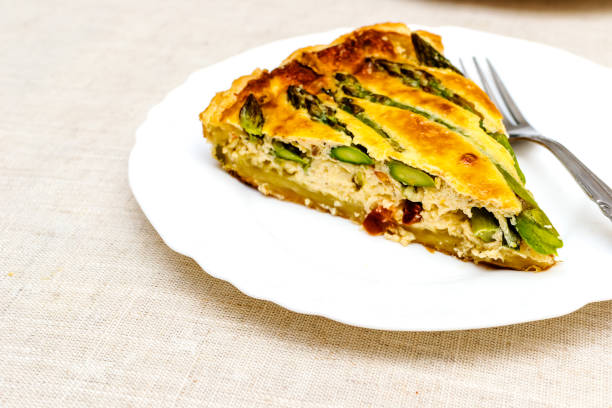 istock Tart with green asparagus and toasted cheese on the table 1220614904