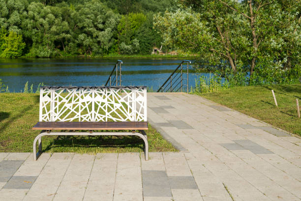istock Bench near the river with a concrete path. 1220617441