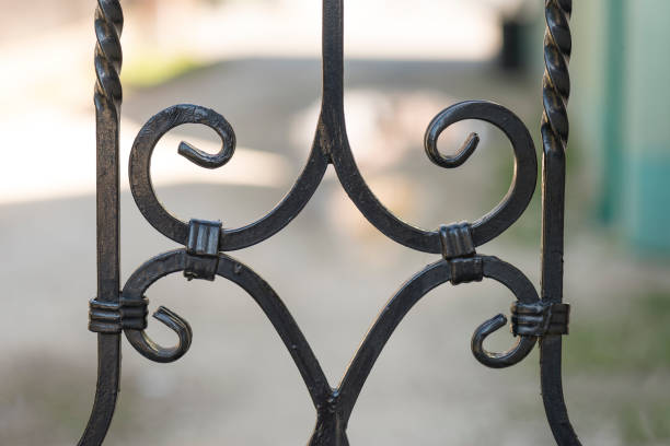 istock Black iron gate detail with curves 1220618880