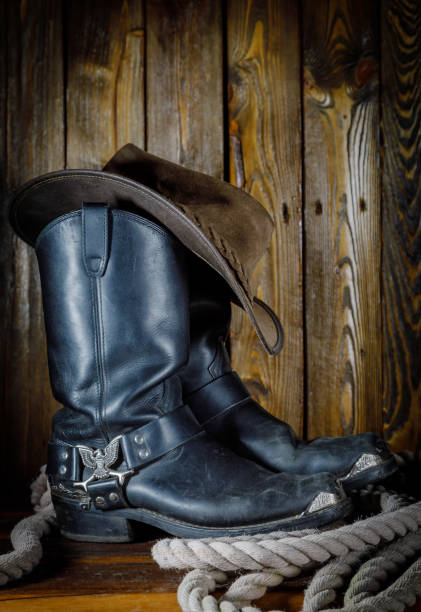 istock cowboy hat, boots and rope on wooden background 1220619078