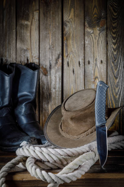 istock cowboy hat, boots and rope on wooden background 1220619406