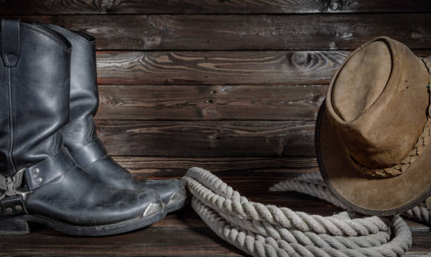istock cowboy hat, boots and rope on wooden background 1220619783