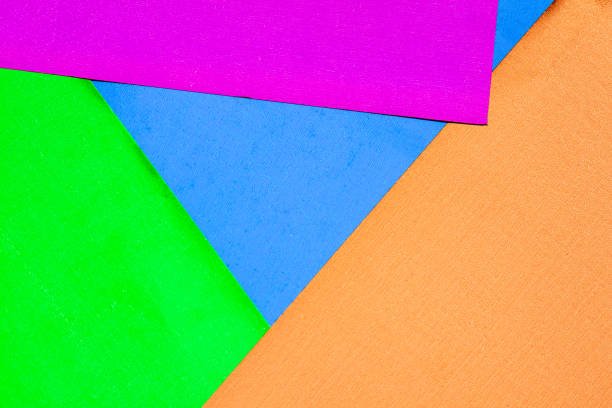 istock Background from multi-colored shiny cardboard. Needlework and children's art, made by hand. Orange, blue, green and magenta metallic colors 1220619840