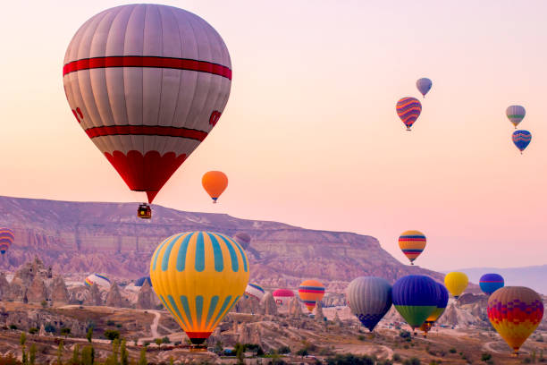 istock Colored balloons at dawn smack over the valley. 1220620724