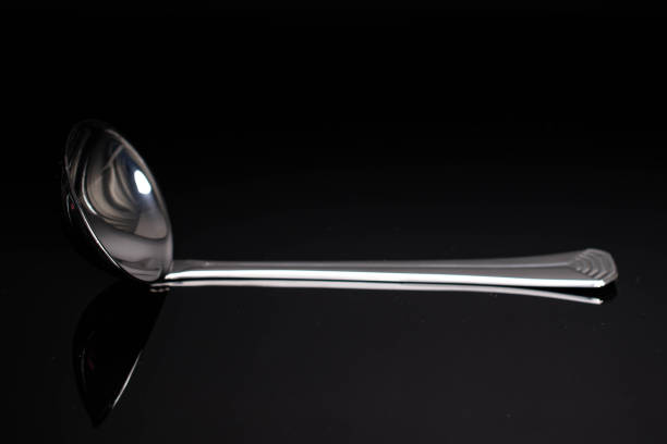 istock Steel cutlery on black glass 1220620802