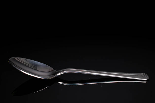 istock Steel cutlery on black glass 1220620803