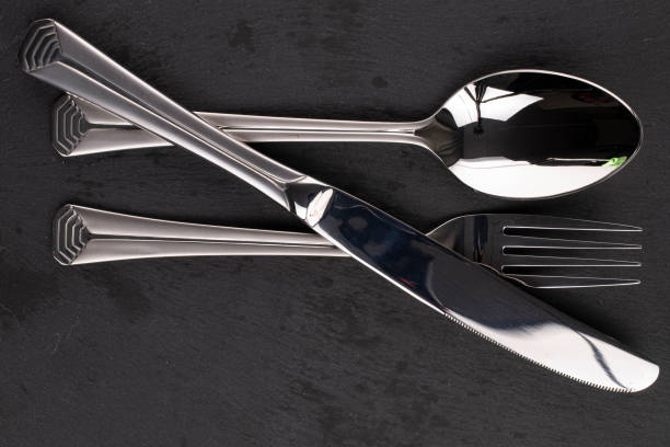 istock Steel cutlery on black glass 1220620862