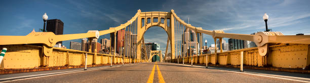 Downtown skyline and the Roberto Clemente Bridge in Pittsburgh Pennsylvania USA Panoramic of the Roberto Clemente Bridge in downtown Pittsburgh Pennsylvania USA sixth street bridge stock pictures, royalty-free photos & images