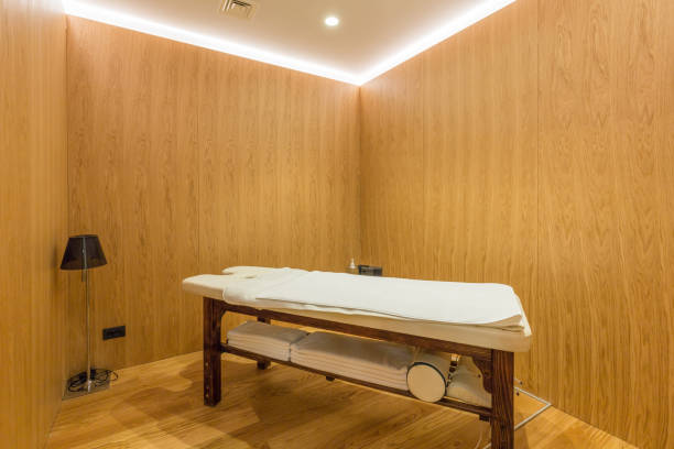 istock Massage room interior with table in hotel wellness center 1220624521