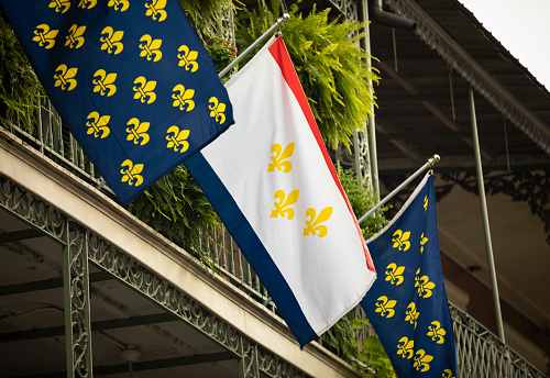 Fleur de lys Flag of New Orleans Louisiana USA hangs by the historic terrace of the French Quarter by Bourbon Street
