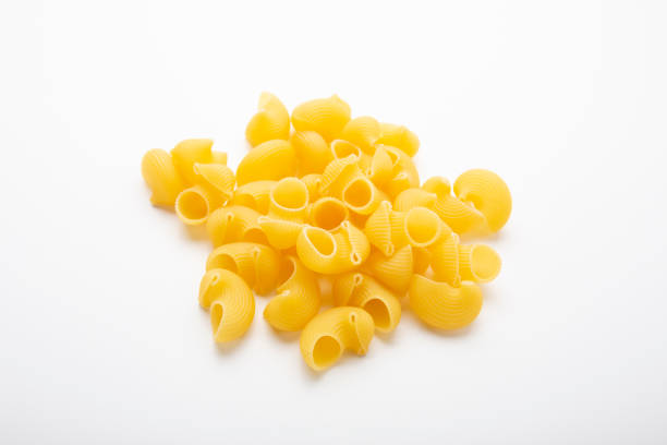 istock Striped sea shell shaped pasta isolated on white background 1220625211