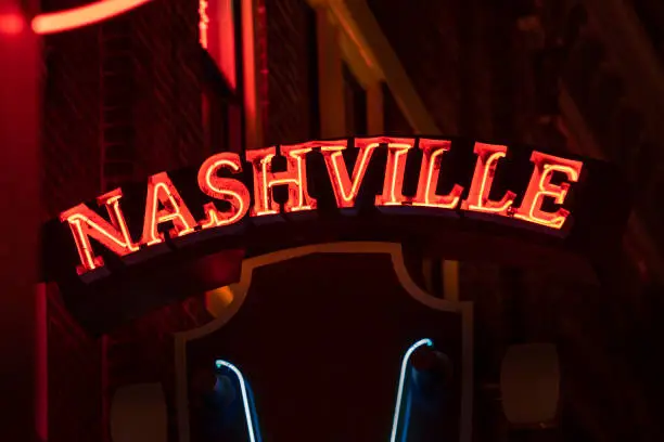 Nashville music city colorful neon sign hanging on Broadway in downtown Nashville Tennessee USA