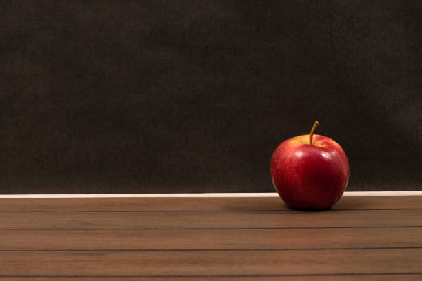 istock Red apple isolated on a wooden table 1220625333