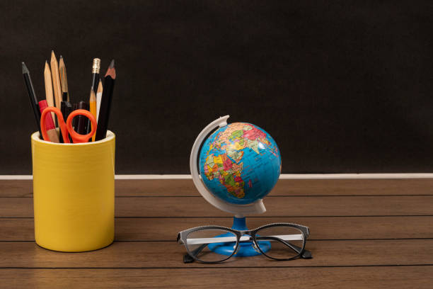 istock A stand with pencils and scissors, a globe and glasses 1220626295