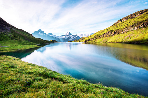 Fantastic landscape with the lake in the Swiss Alps. Wetterhorn, Schreckhorn, Finsteraarhorn et Bachsee. exotic places. magical scenes. (relaxation, harmony - concept).