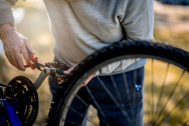 istock Senior man repairing bicycle 1220627972