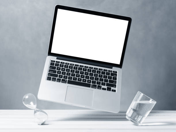 istock Laptop mockup, computer with blank screen flying under the table. Symbol of lightness freshness airiness. Modern technologies social networks and applications. Copy space 1220628137