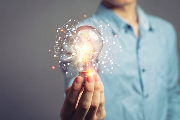 Man holding light bulbs, ideas of new ideas with innovative technology and creativity.