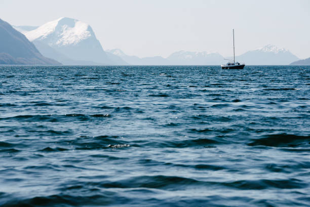 Idyllic scenery - a small boat sailing in a waters of Storfjorden, Norway