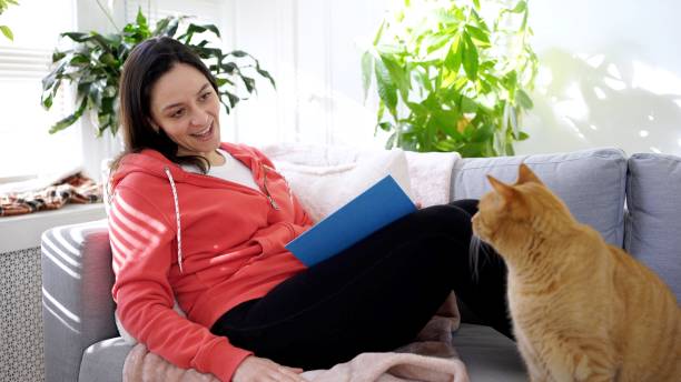 istock Woman reading a book in the room 1220629888