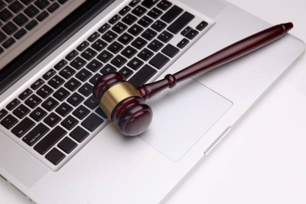 Closeup of laptop and mallet on table in courtroom gavel on white laptop. Concept -online Auction gavel keyboard stock pictures, royalty-free photos & images