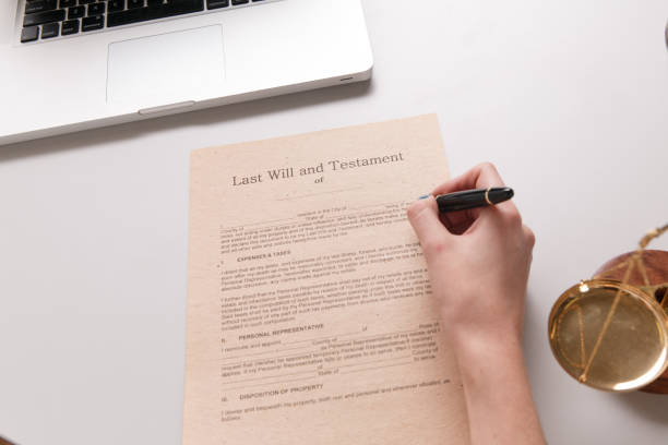 istock Notary woman writing by the pen on the documents 1220632447
