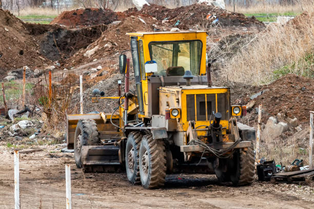 istock Yellow grader in a landfill 1220632812