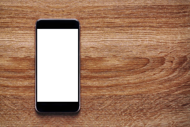 istock Smartphone with Mockup image white screen On Wooden Table With beautiful patterns And copy space for adding content. 1220634469