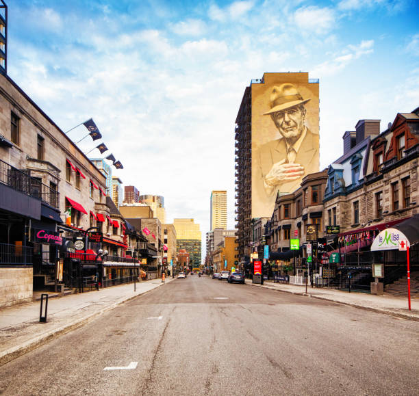 Downtown Montreal Crescent street with Leonard Cohen Murale. Photographed at sunset during the 2020 Coronavirus lockdown, explaining the absence of people on this otherwise hugely popular nightlife street.