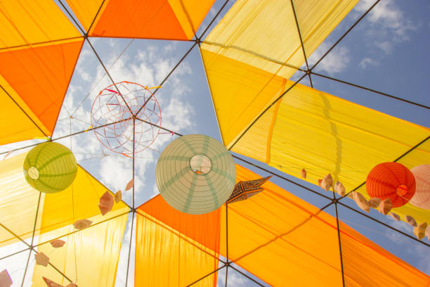 istock Hanging paper sphere lights for a party with a blue sky background. 1220636171