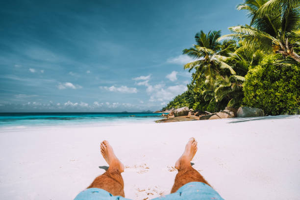 man resting on the white sand beach with beautiful palm trees man resting on the white sand beach with beautiful palm trees. boracay photos stock pictures, royalty-free photos & images