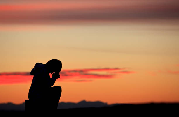 istock Silhouette of Boy Praying 1220638362