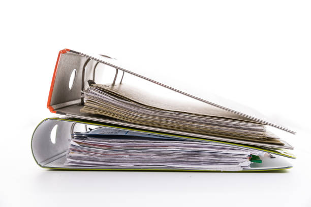istock Folders filled with documents on white background. Symbol of business or bureaucracy 1220638372